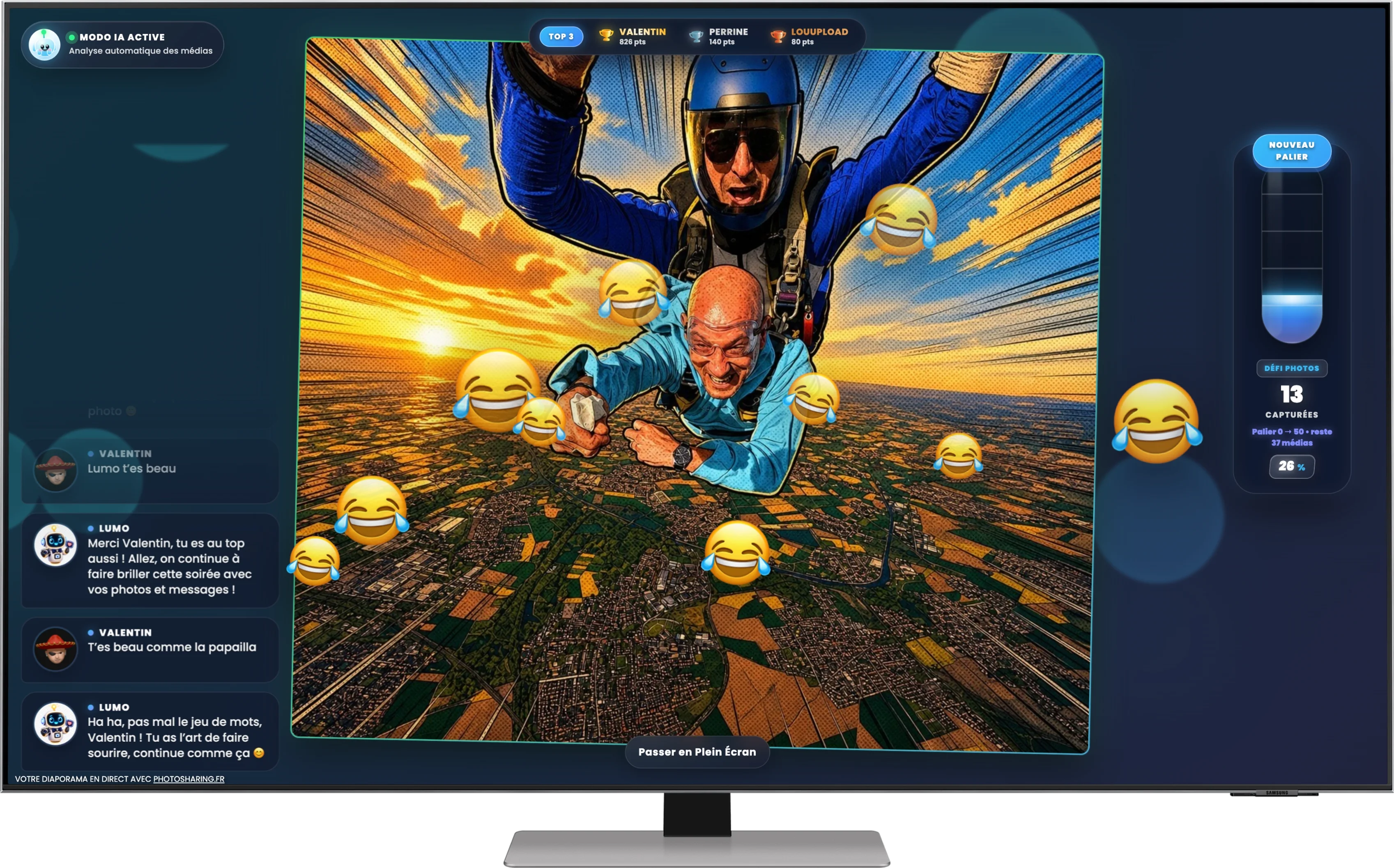 Monitor showing a dark photo-sharing slideshow with two harnessed people in free fall, laughing emojis, comments, a ranking and a progress gauge